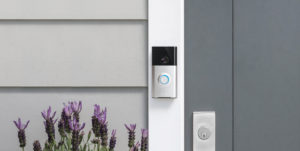 Image of a Ring Video Doorbell hanging on a door frame.